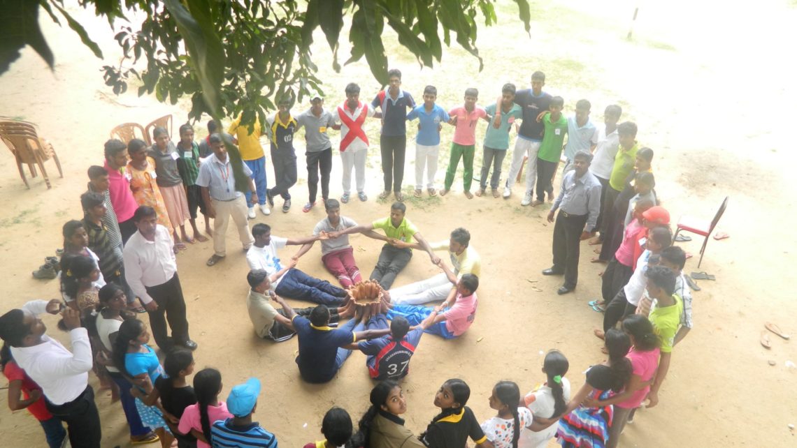 Students perform team building exercises